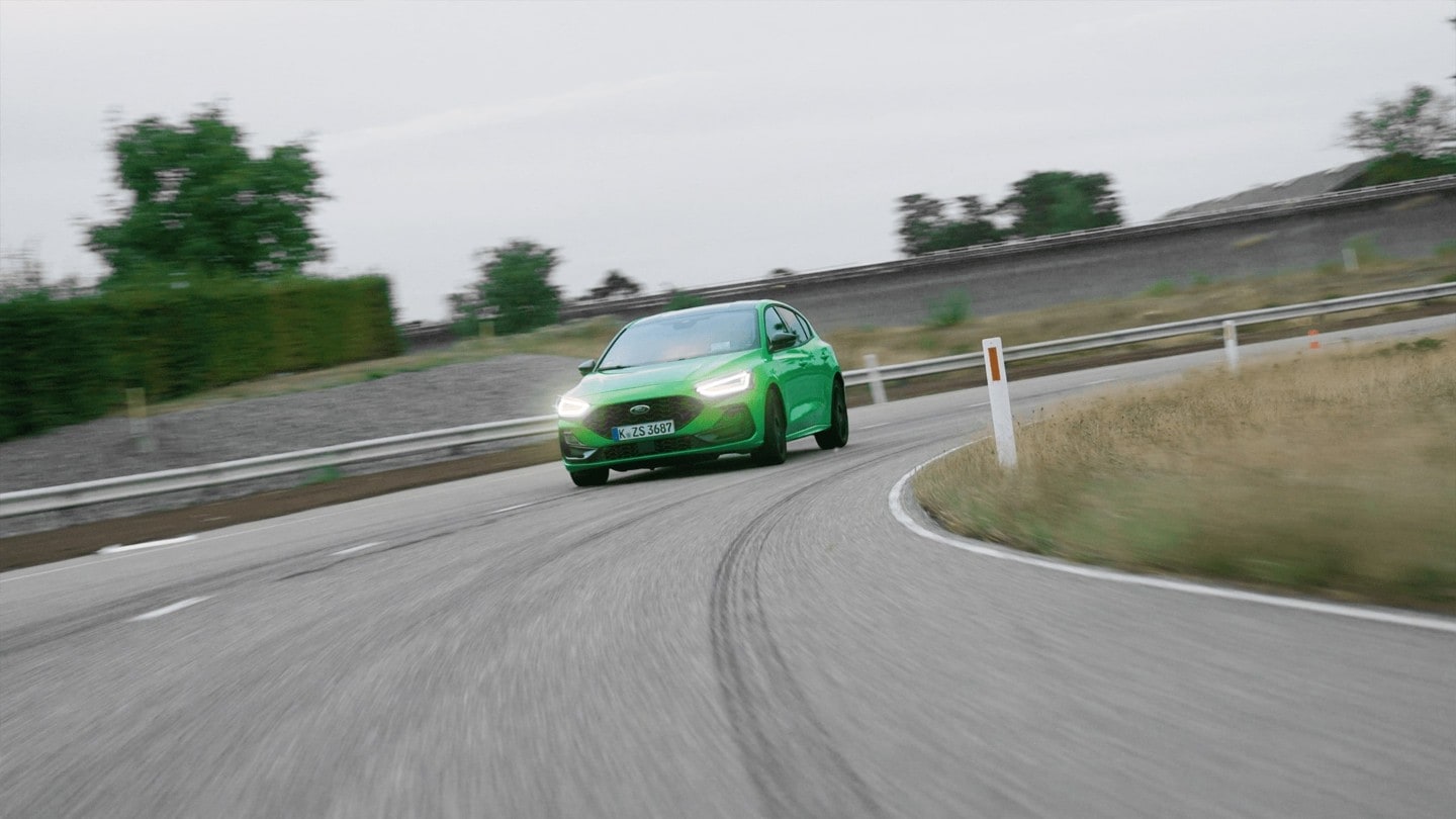 Green Ford Focus on the road