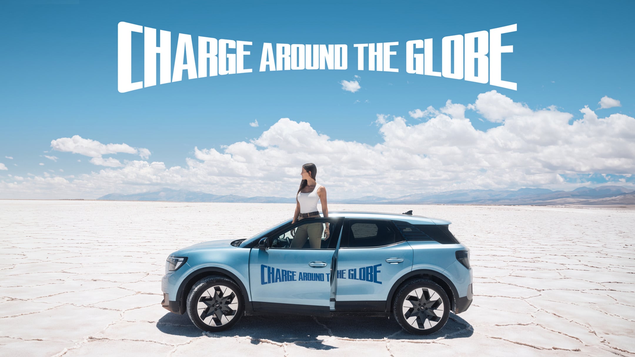 Lexie Alford, (AKA Lexie Limitless), standing in a desert with the New Ford Electric Explorer