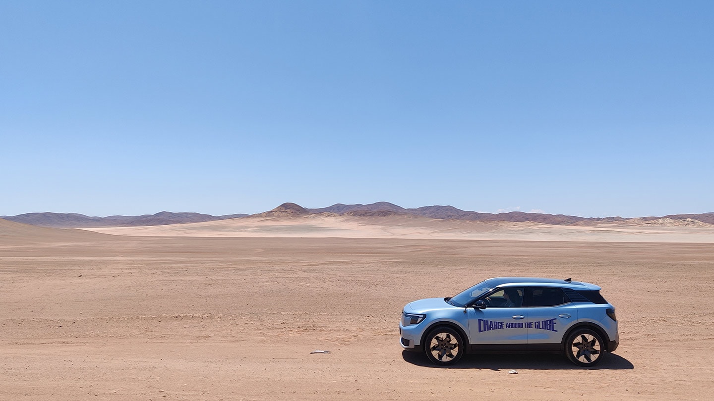 The electric Ford Explorer driving through the desert during the Charge Around the Globe challenge.
