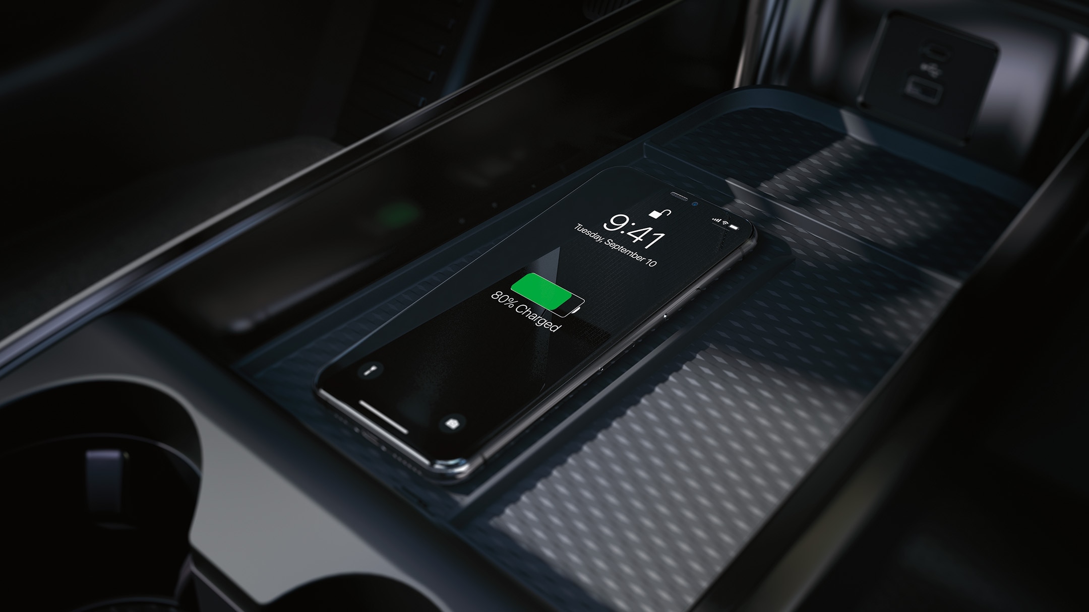 Een close-up van het draadloze oplaadstation in de middenconsole, waarop een iPhone wordt opgeladen.