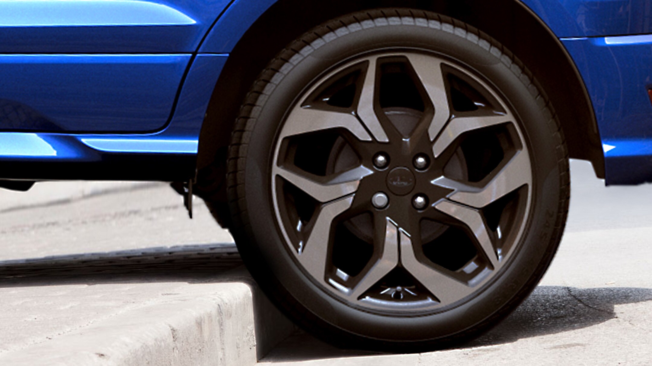 Blue Ford EcoSport rear wheel mounting high kerb