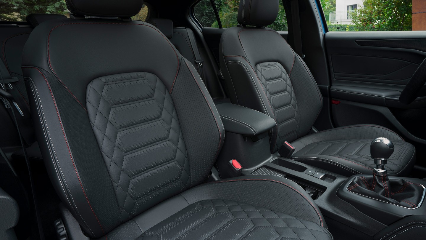 Front seats of a Ford Focus showing red stitching