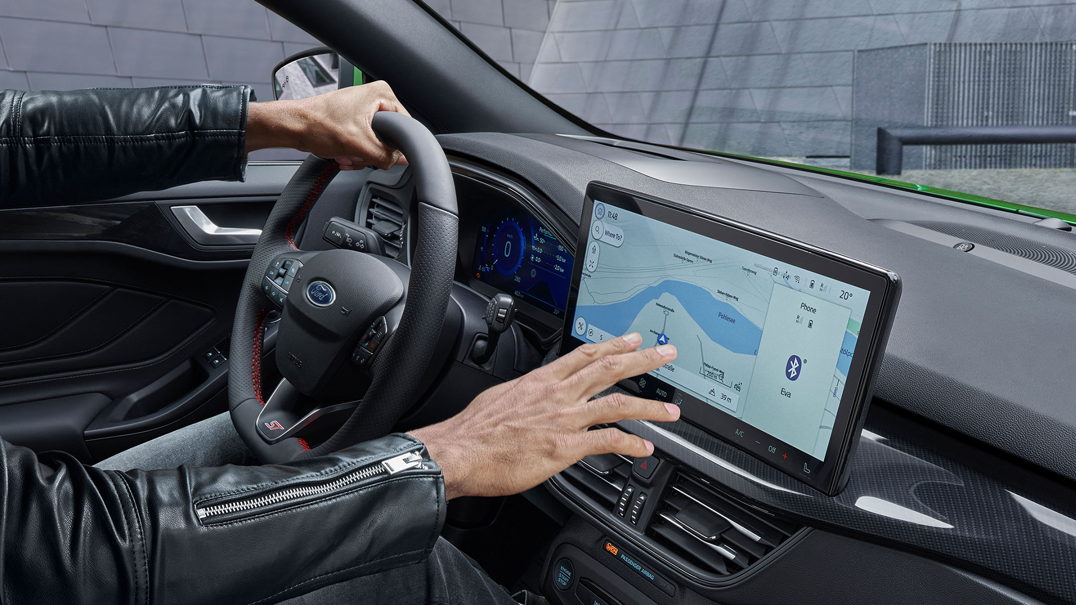 Hand interacting with a touchscreen on a dashboard