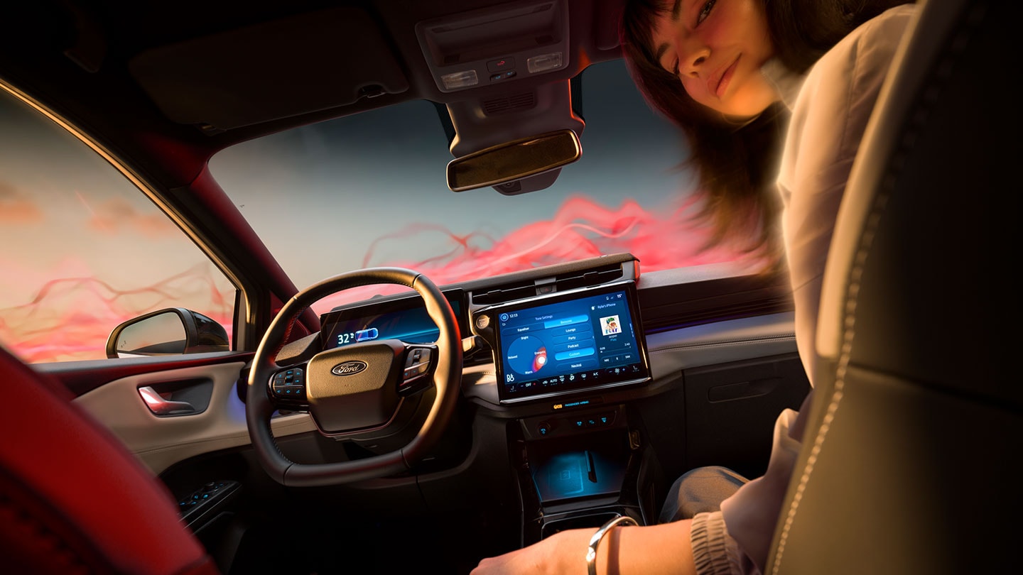 Het interieur van de Ford Puma Gen-E Sound Edition met een vrouw op de passagiersstoel.