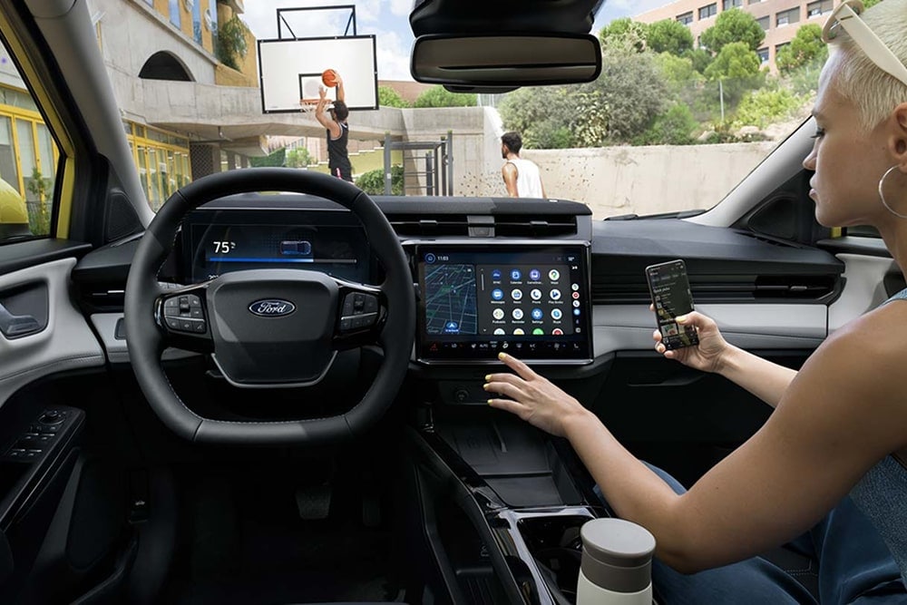 Interieur van de kleine auto Ford Puma Gen-E, met touchscreen-bediening.