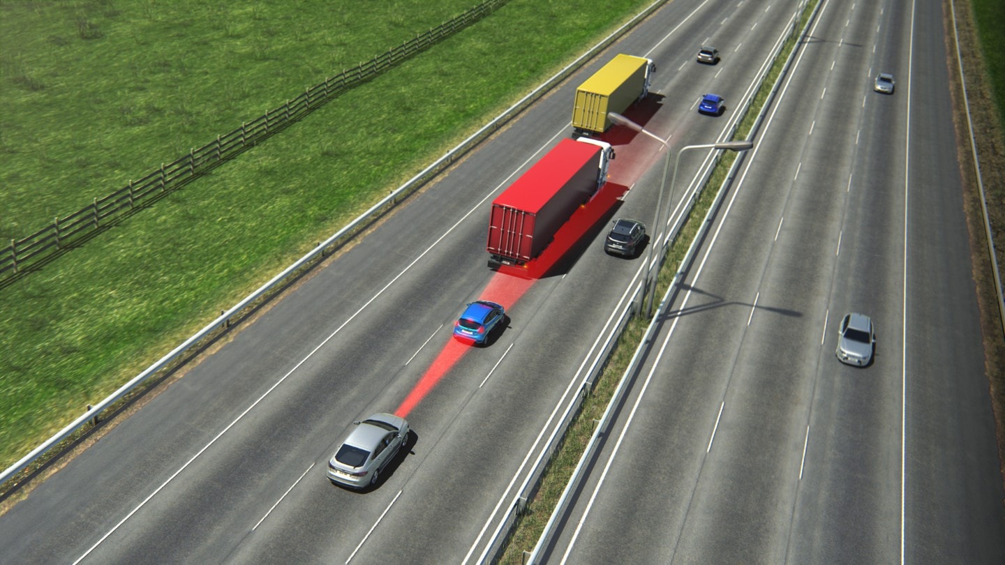 A highway with last car having turned on the Pre-Collision Assist