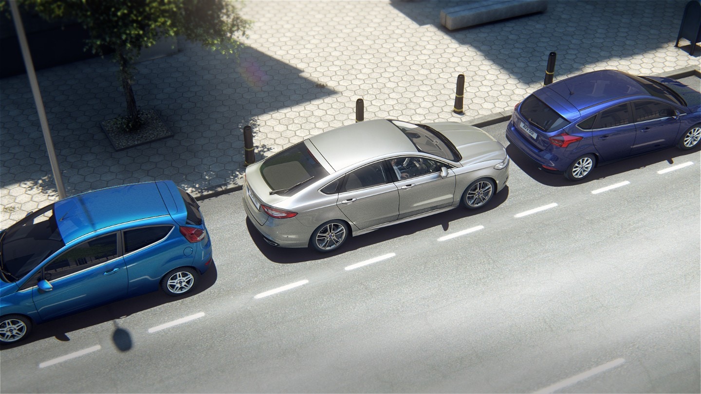 Silver Ford Mondeo parked between blue Ford Fiesta and Ford Focus