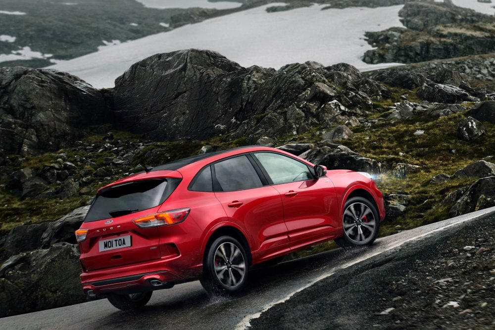 Red Ford Kuga driving along rocky curve