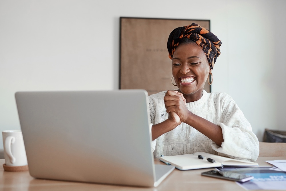 Women laughing whilst looking at laptop