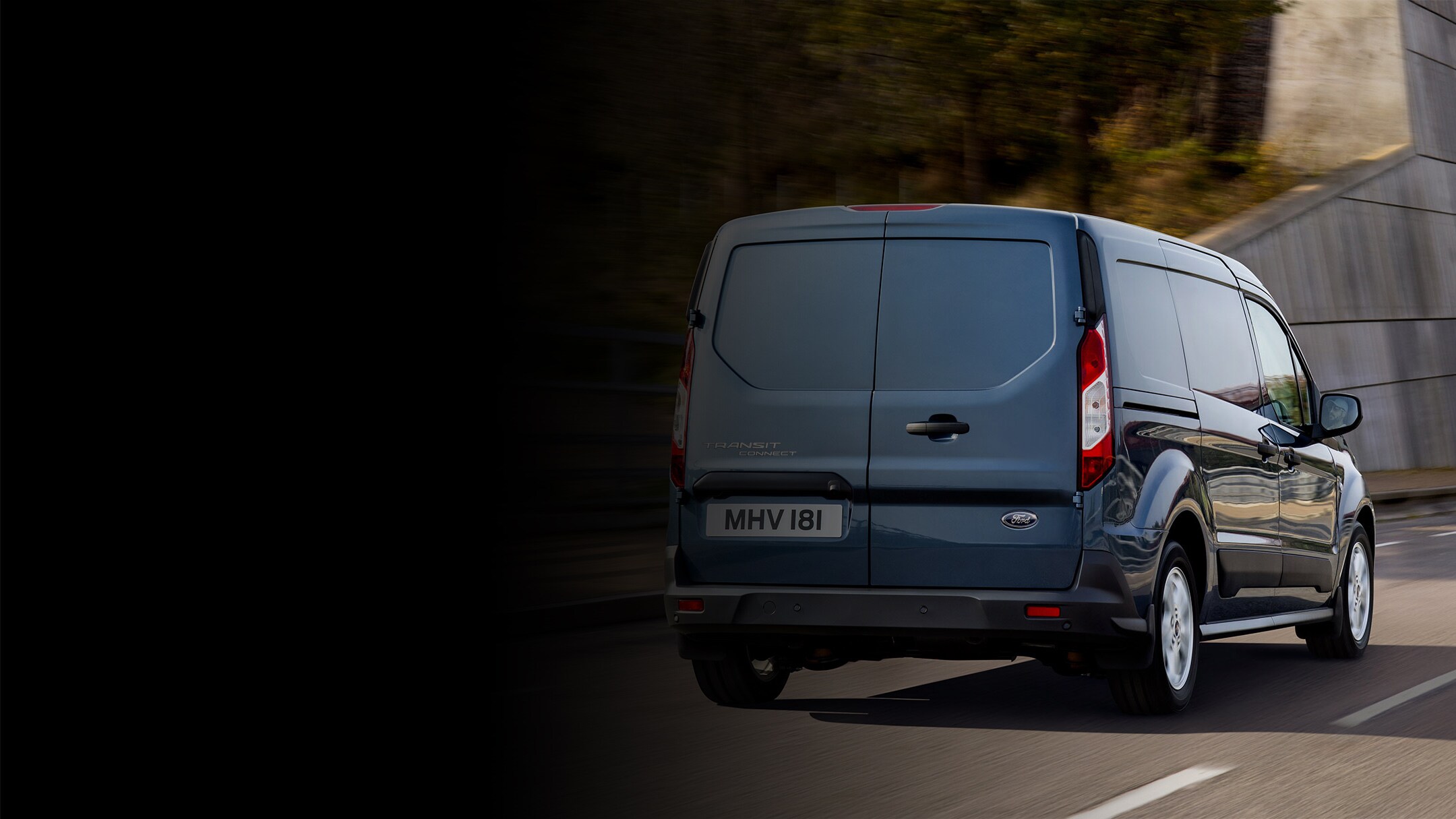 Blue Ford Transit Connect on highway