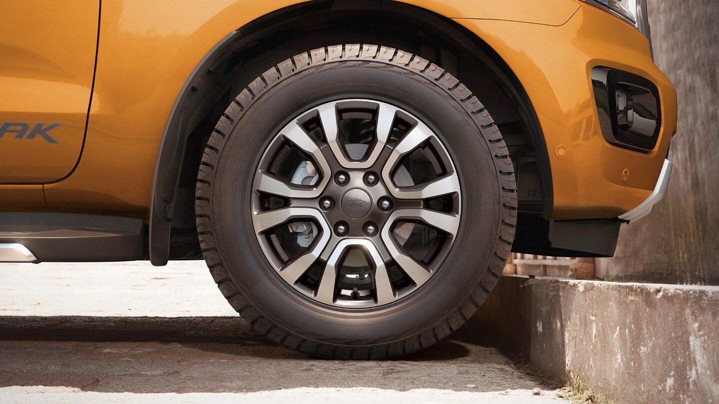 Orange Ford Ranger front wheel close up