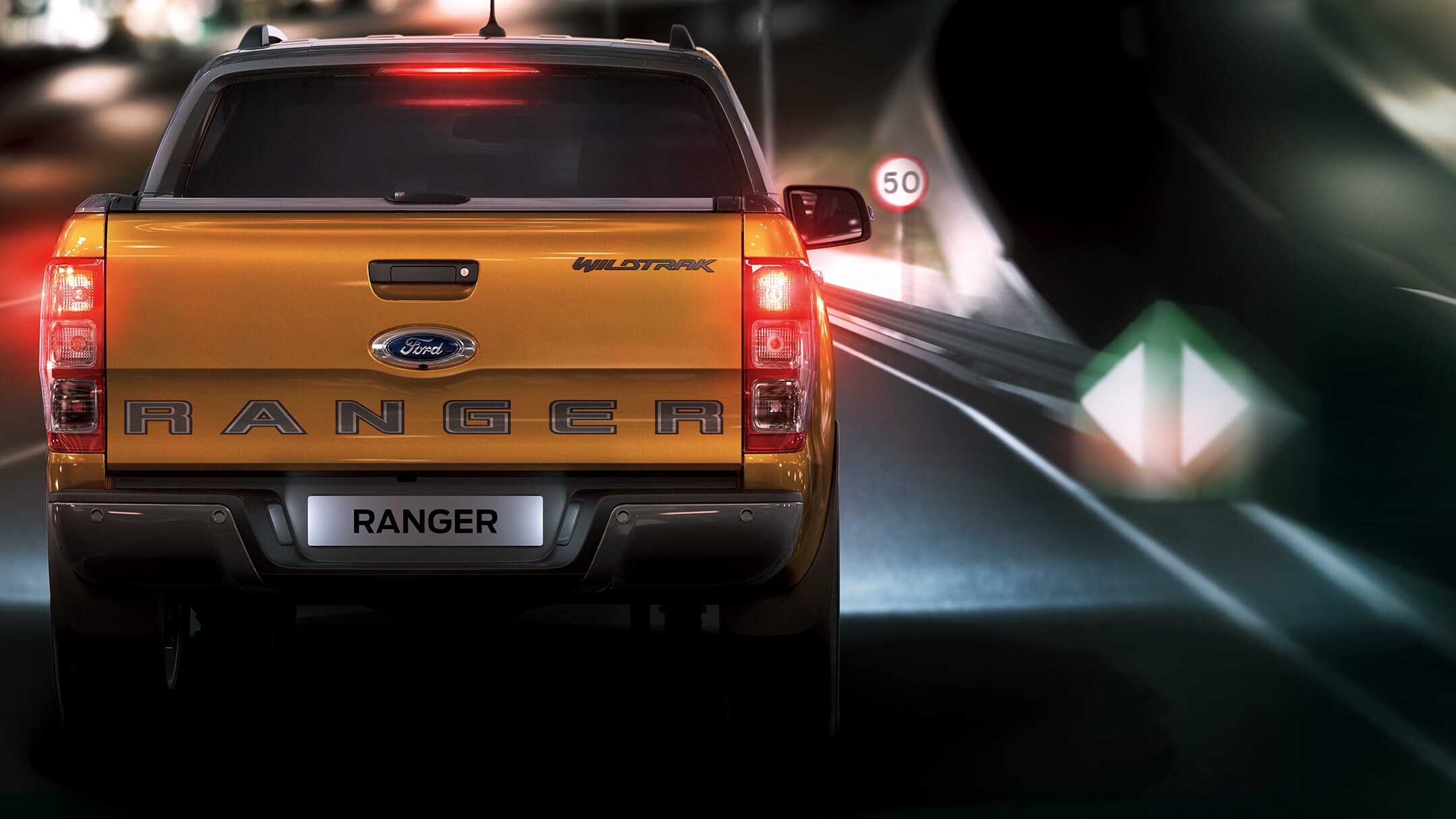 Orange Ford Ranger rear view with traffic sign recognition