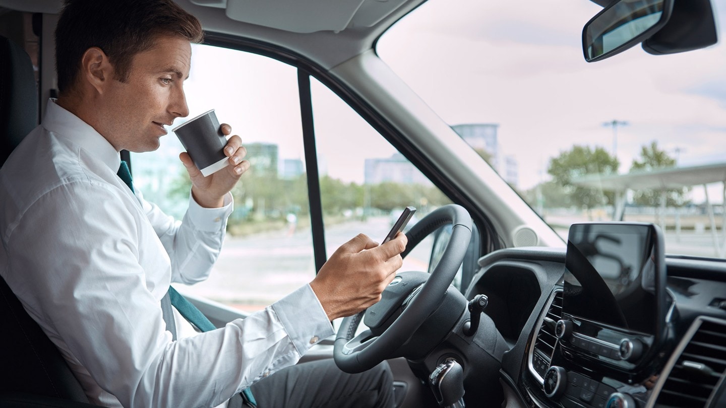 Ford Transit Van interior with person drinking coffee