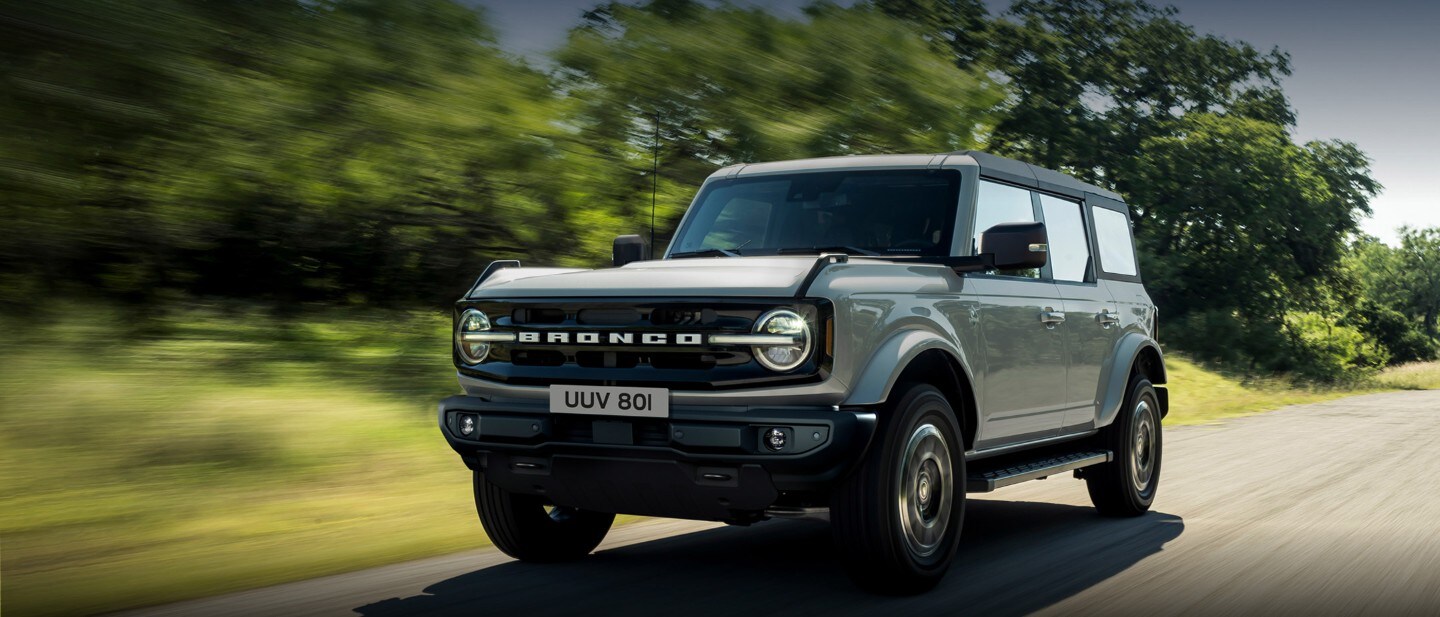 Ford Bronco driving through woods