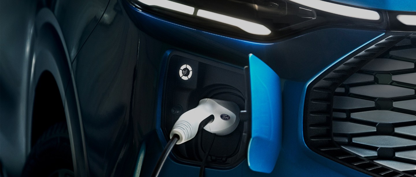 Ford electric vehicle charger plugged into a blue ford vehicle