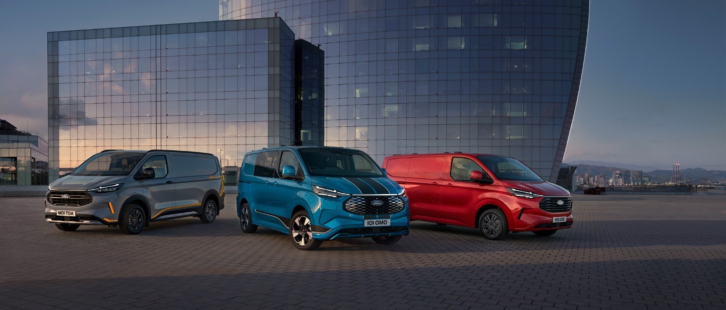 Three Ford Transit Custom Vans in grey, blue and red, parked side by side