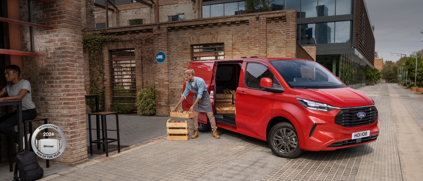 Red ford transit custom with a person making a delivery