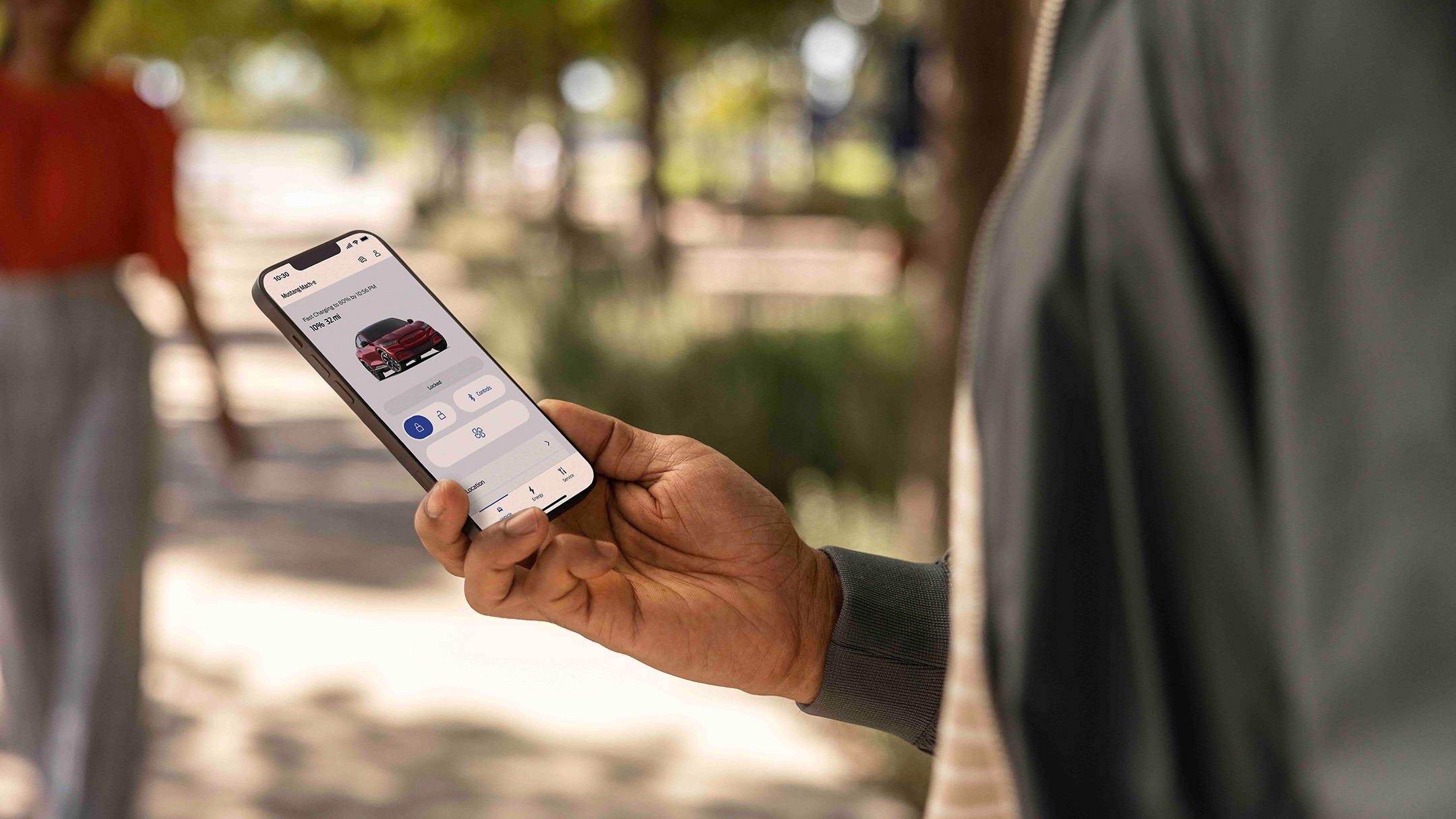 Man looking at a smartphone with FordPass App