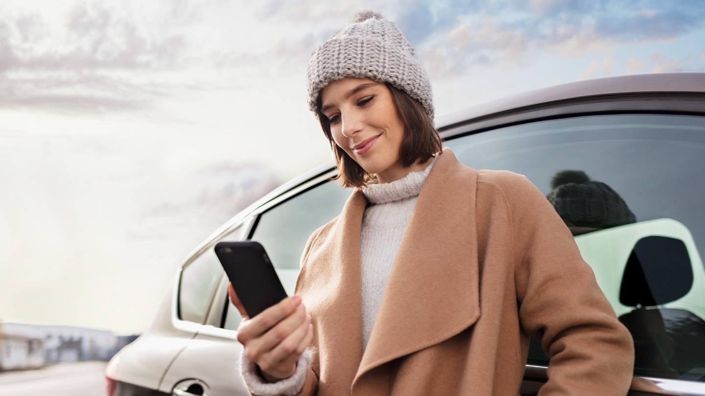 Smiling woman looking at her smartphone