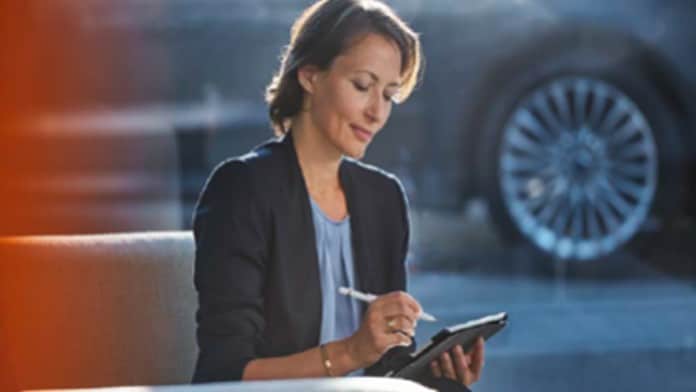 Woman checking fleet financing options on tablet
